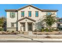 Two-story house with light-colored exterior, landscaping, and a gated entryway at 11695 N 166Th Ln, Surprise, AZ 85388