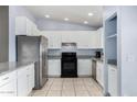 Kitchen boasts white cabinets, stainless steel appliances, and granite countertops at 1208 E Hess Ave, Phoenix, AZ 85034