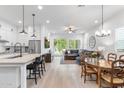 Open-concept living area with modern kitchen, dining space, and comfortable seating at 1332 E Sierra Vista Dr, Phoenix, AZ 85014