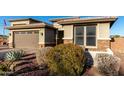 Lovely home featuring low-maintenance landscaping, brick accents, and a three-car garage at 13855 S 181St Ave, Goodyear, AZ 85338