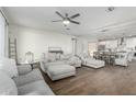 Bright and airy living room with hardwood floors seamlessly connected to dining area at 13855 S 181St Ave, Goodyear, AZ 85338