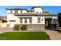 Two-story house with stone accents and a three car garage at 15446 W Montecito Ave, Goodyear, AZ 85395