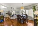 Open dining area with hardwood floors and a dark wood table at 15801 N 51St St, Scottsdale, AZ 85254