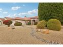 One-story home with a well-maintained front yard and rock garden at 16220 W Red Rock Dr, Surprise, AZ 85374