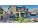 Two-story house with landscaped yard, two-car garage, and a welcoming front porch at 1811 E Powell Way, Chandler, AZ 85249