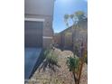 Side yard with gravel and a gate leading to the backyard at 18225 W Yavapai St, Goodyear, AZ 85338