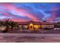 Beautiful ranch house exterior at sunset, featuring a tile roof and stone accents at 18509 W Bethany Home Rd, Litchfield Park, AZ 85340