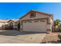 One-story house with beige exterior, two-car garage, and landscaped front yard at 19045 N 47Th Cir, Glendale, AZ 85308