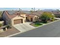 Single-story home with solar panels, two-car garage, and landscaped yard at 2005 N 169Th Ave, Goodyear, AZ 85395