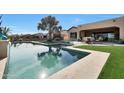 Backyard pool with travertine tile and artificial grass, perfect for outdoor relaxation at 2005 N 169Th Ave, Goodyear, AZ 85395