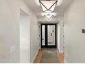 Bright hallway with light wood floors and modern light fixtures at 2430 E Palo Verde Dr, Phoenix, AZ 85016