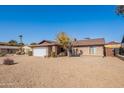 Ranch style home with gravel driveway and mature tree at 2454 W Hearn Rd, Phoenix, AZ 85023