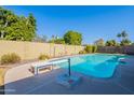 Inviting blue pool with diving board and patio area at 2454 W Hearn Rd, Phoenix, AZ 85023