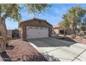 View of the garage and driveway of a one-story home at 24833 W Jessica Ln, Buckeye, AZ 85326