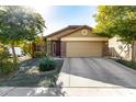 Tan house with a two-car garage and stone accents at 2731 W Wayland Dr, Phoenix, AZ 85041