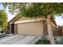 Tan house with a two-car garage and stone accents at 2731 W Wayland Dr, Phoenix, AZ 85041