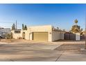 House exterior showcasing a green garage door and drought-tolerant landscaping at 2916 S Price Rd, Tempe, AZ 85282