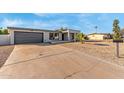 Newly renovated home with modern facade, two-car garage, and driveway at 3301 E Larkspur Dr, Phoenix, AZ 85032