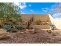 Landscaped backyard with fire pit and built-in grill at 33612 N 24Th Dr, Phoenix, AZ 85085