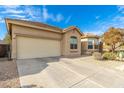 Two-car garage with driveway and desert landscaping at 33612 N 24Th Dr, Phoenix, AZ 85085