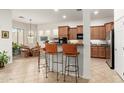 Kitchen with wood cabinets, granite countertops and bar seating at 33612 N 24Th Dr, Phoenix, AZ 85085