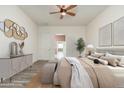 Spacious main bedroom features soft colors, a ceiling fan, and wood-look flooring at 33612 N 24Th Dr, Phoenix, AZ 85085