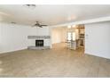 Spacious living room with tile floors, fireplace, and kitchen views at 3554 W Royal Palm Rd, Phoenix, AZ 85051