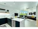 Contemporary kitchen boasts white countertops and dark cabinetry at 3707 N Marshall Way # 3, Scottsdale, AZ 85251