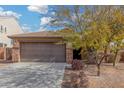 House exterior with a brown garage door, stone accents, and landscaping at 3905 S 185Th Ln, Goodyear, AZ 85338