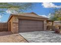 House exterior with a brown garage door and stone accents at 3905 S 185Th Ln, Goodyear, AZ 85338