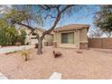 One-story home with a large tree and gravel yard at 4170 E Winged Foot Pl, Chandler, AZ 85249