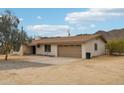 Single-Gathering home with desert landscaping, an attached garage, and a concrete driveway at 43006 N 3Rd Ave, New River, AZ 85087