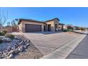 House exterior showing a driveway, garage and landscaping at 4557 W Agave Ave, Eloy, AZ 85131