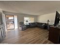 Living room featuring a sectional sofa, recliner, and wood-look flooring at 4624 E Emerald Ave, Mesa, AZ 85206