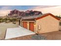 Two-car garage with orange doors and mountain views at 5063 E Reavis St, Apache Junction, AZ 85119