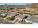 Aerial view of a residential area with houses and desert landscape at 5252 N 206Th Dr, Buckeye, AZ 85396