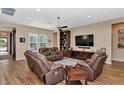 Relaxing living room with brown leather recliners, a large TV, and built-in shelving at 5252 N 206Th Dr, Buckeye, AZ 85396