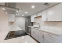 Modern kitchen featuring white cabinets, quartz countertops, and stainless steel appliances at 600 S Dobson Rd # 166, Mesa, AZ 85202