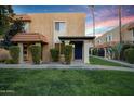 Tan stucco building with a blue front door and landscaped lawn at 601 E Palo Verde Dr # 14A, Phoenix, AZ 85012