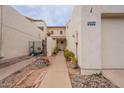 Inviting entryway with a paved pathway, landscaping, and access to the garage at 7764 N 19Th Dr, Phoenix, AZ 85021