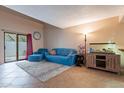 Cozy living room featuring a blue sofa and a large fish tank at 7764 N 19Th Dr, Phoenix, AZ 85021