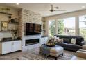 Living room with fireplace, large TV, and comfortable seating at 813 E Verde Blvd, Queen Creek, AZ 85140