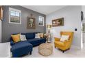 Living room with sectional sofa, accent chair, and coffee table at 850 E Del Rio St, Chandler, AZ 85225