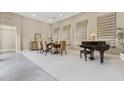 Bright dining area with a piano, a wood table and four chairs, carpeted floor, and lots of natural light at 8534 E Angel Spirit Dr, Scottsdale, AZ 85255