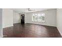 Bright living room with dark wood-look floors and plantation shutters at 8614 E Valley View Rd, Scottsdale, AZ 85250