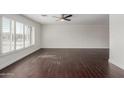 Spacious living room featuring dark wood-look floors and large windows at 8614 E Valley View Rd, Scottsdale, AZ 85250