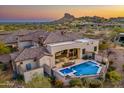 Aerial image showcasing home with a sparkling pool, patio, and desert landscaping at 9505 E Superstition Mountain Dr, Gold Canyon, AZ 85118