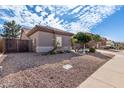 House exterior showcasing desert landscaping and a gated entry at 9745 E Natal Ave, Mesa, AZ 85209