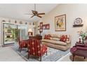 Cozy living room featuring vaulted ceilings, a ceiling fan, and sliding doors to the outdoor space at 10206 N 105Th Way, Scottsdale, AZ 85258