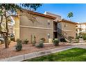 Condo building with landscaping, walkway, and parking area at 10410 N Cave Creek Rd # 2060, Phoenix, AZ 85020